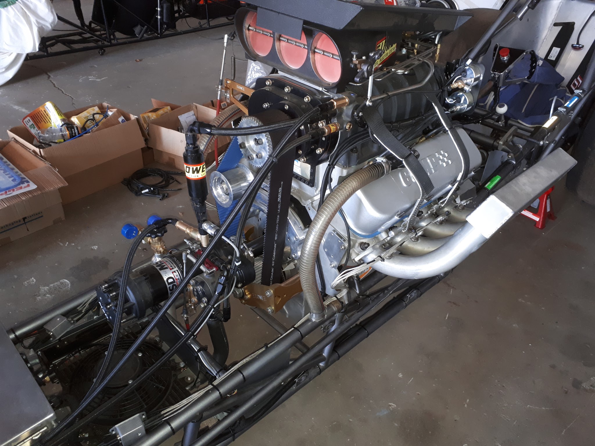 Blown and injected V8 mounted in a drag car chassis, with the loom routed and strapped along the rail