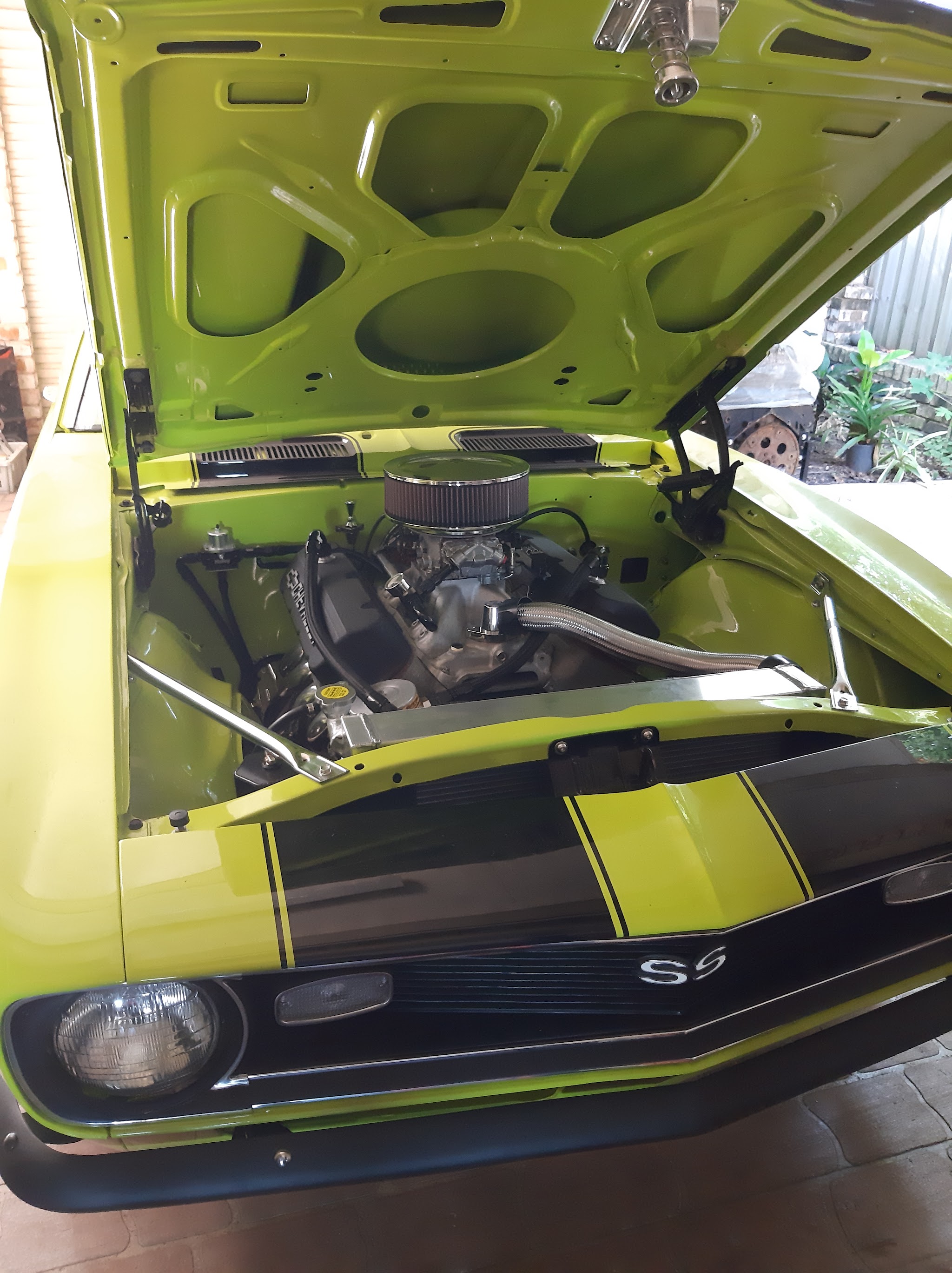 Lime green Holden Torana SS with the bonnet up, showing a Chevrolet V8 with a chrome air cleaner